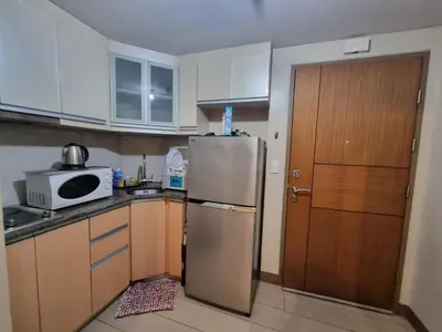 a kitchen with a refrigerator and a microwave at Palm Tree Condos near MNL Airport Terminal 3 by ELR in Manila