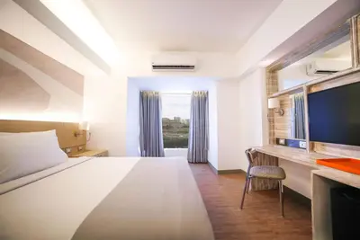 a hotel room with a bed and a desk at TRYP by Wyndham Mall of Asia Manila in Manila