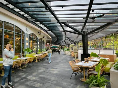 a man talking on a cell phone in a restaurant at KL Executive Greenbelt (KLX) in Manila