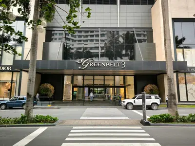 a building with cars parked in front of it at KL Executive Greenbelt (KLX) in Manila