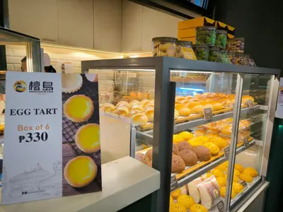 a display case in a store filled with lots of donuts at KL Executive Greenbelt (KLX) in Manila