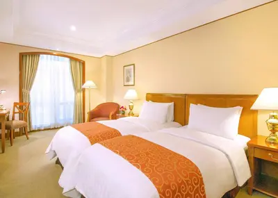 a hotel room with two beds and a window at Richmonde Hotel Ortigas, Manila in Manila
