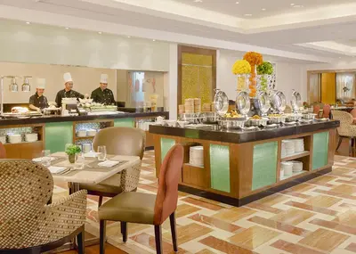 a restaurant with a counter with dishes on it at Richmonde Hotel Ortigas, Manila in Manila