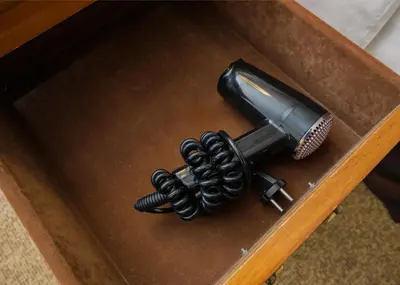 a hair dryer and a hair brush on a table at Richmonde Hotel Ortigas, Manila in Manila