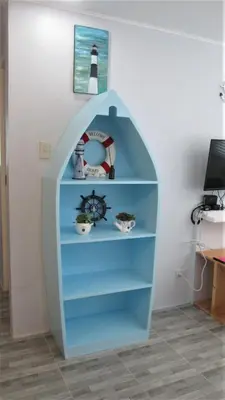a blue book shelf in a room with a lighthouse at Homestay at 24 Laguna Bel-Air by Red Door House Rental in Santa Rosa