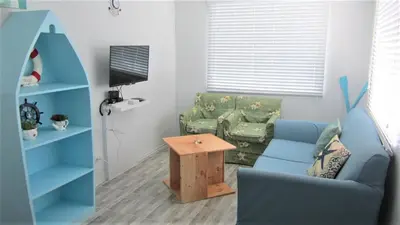 a living room with a couch and a blue chair at Homestay at 24 Laguna Bel-Air by Red Door House Rental in Santa Rosa