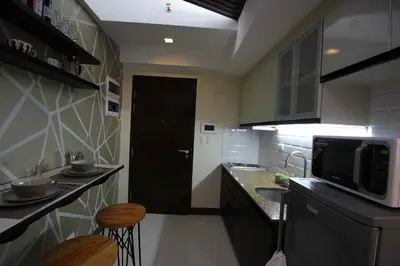a small kitchen with a counter and a microwave at 5E Tower 2 Viceroy in Manila