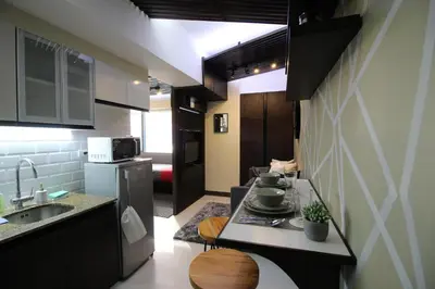 a kitchen with a sink and a stove top oven at 5E Tower 2 Viceroy in Manila