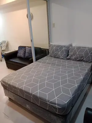 a bedroom with a bed and a couch at Azure Residences by Van Florendo in Manila