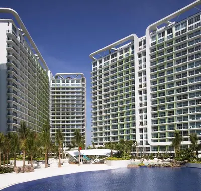 two tall buildings with a pool in front of them at Azure Urban Beach Resort Manila by Radlett in Manila