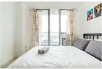 a bed with a stuffed animal on top of it at Joanne Sweet Home in Manila