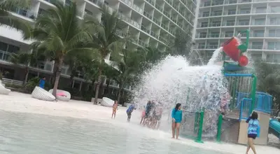 a group of people playing in a fountain on the beach at Joanne Sweet Home in Manila