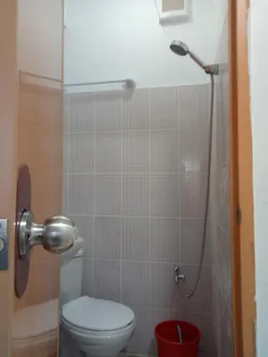 a bathroom with a toilet and a shower at MJ Home in Manila
