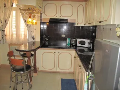 a kitchen with a counter and a table in it at Makati Suites at Travelers Inn in Manila