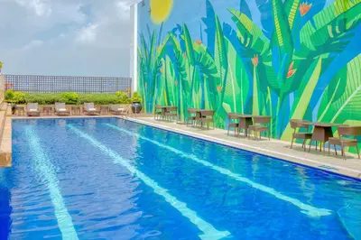 a mural of a pool with tables and chairs at Eastwood Richmonde Hotel Quezon City in Manila