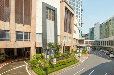 an empty street in a city with tall buildings at Eastwood Richmonde Hotel Quezon City in Manila