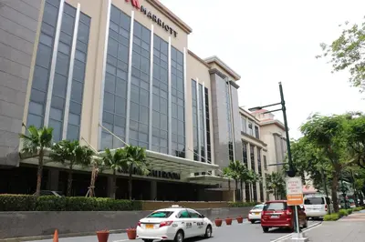 a white car parked in front of a hotel at One Palm Tree Villas MANILA in Manila