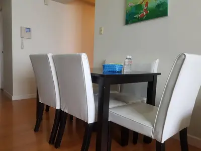 a dining room table with white chairs around it at Eton Baypark in Manila