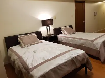 a hotel room with two beds and a lamp at Eton Baypark in Manila