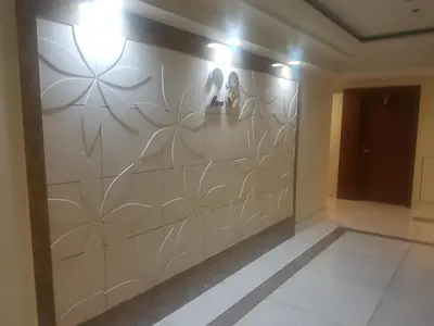 a wall in a hallway with a mural of flowers at Eton Baypark in Manila