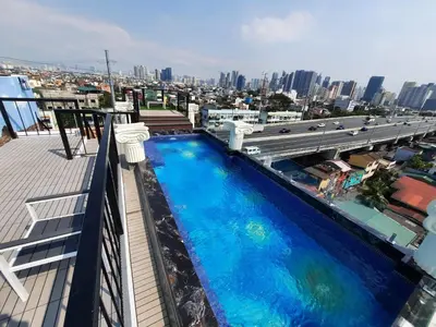a swimming pool on the roof of a building at Heroes Hotel in Manila