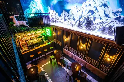 an overhead view of a bar with a mountain mural at Heroes Hotel in Manila