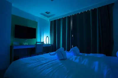 a bedroom with a teddy bear sitting on a bed at Heroes Hotel in Manila