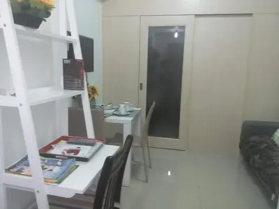 a small room with a table and a shelf at Jazz Hunter Residence in Manila