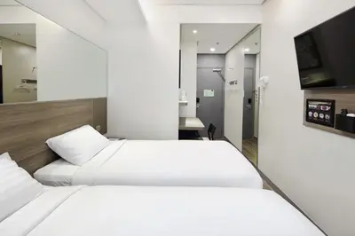 a bedroom with two beds and a television in it at Red Planet Manila Binondo in Manila