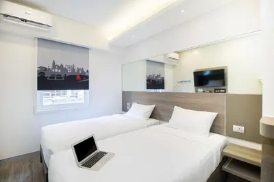a hotel room with two beds with a laptop on it at Red Planet Manila Binondo in Manila