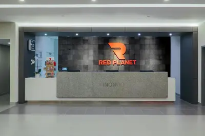 a red planet store with a red planet sign in a lobby at Red Planet Manila Binondo in Manila