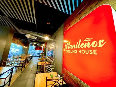 a restaurant with a red sign on the wall at Red Planet Manila Bay in Manila