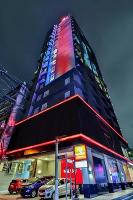 a tall building with lights on the side of it at Red Planet Manila Bay in Manila