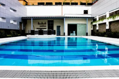 a swimming pool in the middle of a building at Manila Grand Opera Hotel in Manila