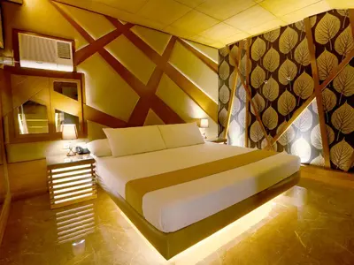 a bedroom with a bed in a room with a wall at Hotel Ava Malate in Manila