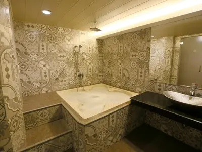 a large bathroom with a tub and a sink at Hotel Ava Malate in Manila