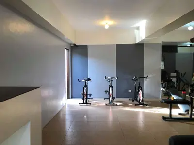 two bikes parked in a room with a gym at Centropolis in Manila