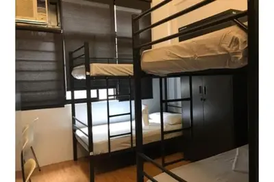 a group of bunk beds in a room at Monchere Dormitory in Manila