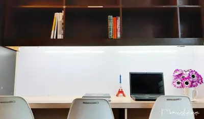 a desk with two chairs and a laptop computer at Monchere Dormitory in Manila