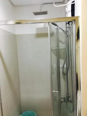 a shower with a glass door in a bathroom at SMDC Light Residences Condominium in Manila