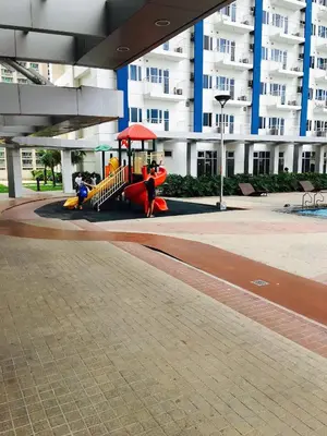 a playground in front of a large building at SMDC Light Residences Condominium in Manila