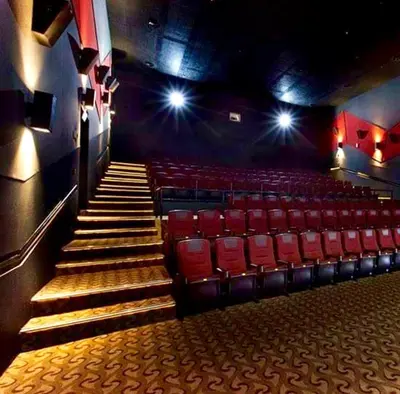 an auditorium with red chairs and stairs in a theatre at SMDC Light Residences Condominium in Manila