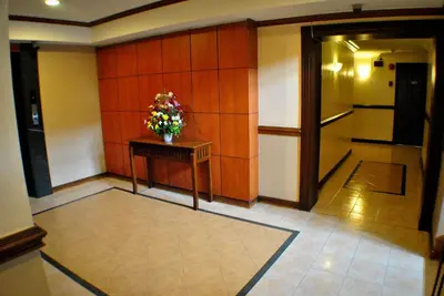 a hallway with a table with a vase of flowers on it at Fersal Hotel - Manila in Manila