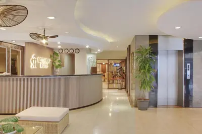 a lobby with a bar in a hotel at Rothman Hotel in Manila