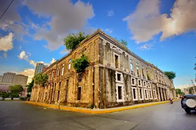 an old stone building on the side of a street at Riviera Mansion Hotel in Manila