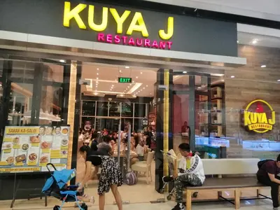 a kova j restaurant with people sitting in front of it at SNAPz Staycation @ Jazz Residences in Manila
