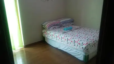 a small bed in a corner of a room at Mmr in Manila