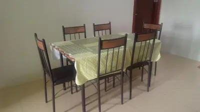 a dining room table and chairs with a green table cloth at Mmr in Manila