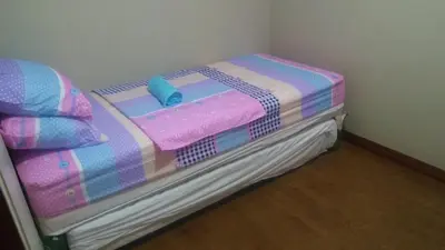 a small bed in a corner of a room at Mmr in Manila