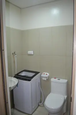 a bathroom with a white toilet and a sink at Jovic's Condo at Breeze Residences. in Manila
